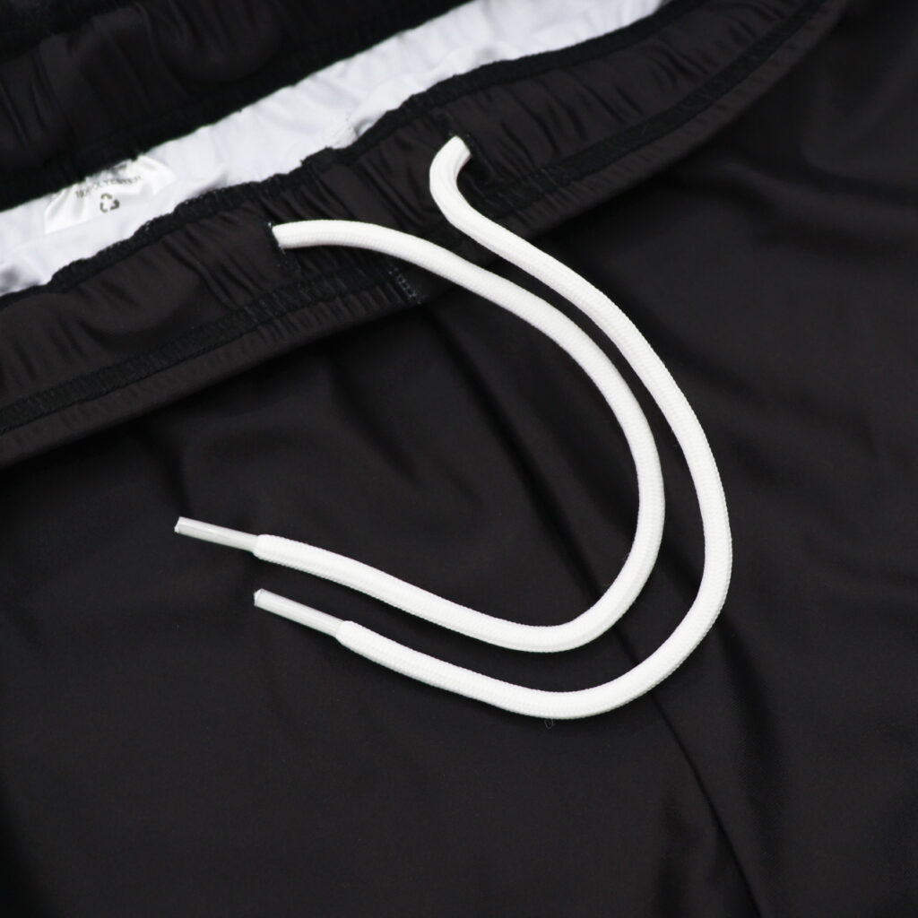 White drawstring detail on black volleyball shorts