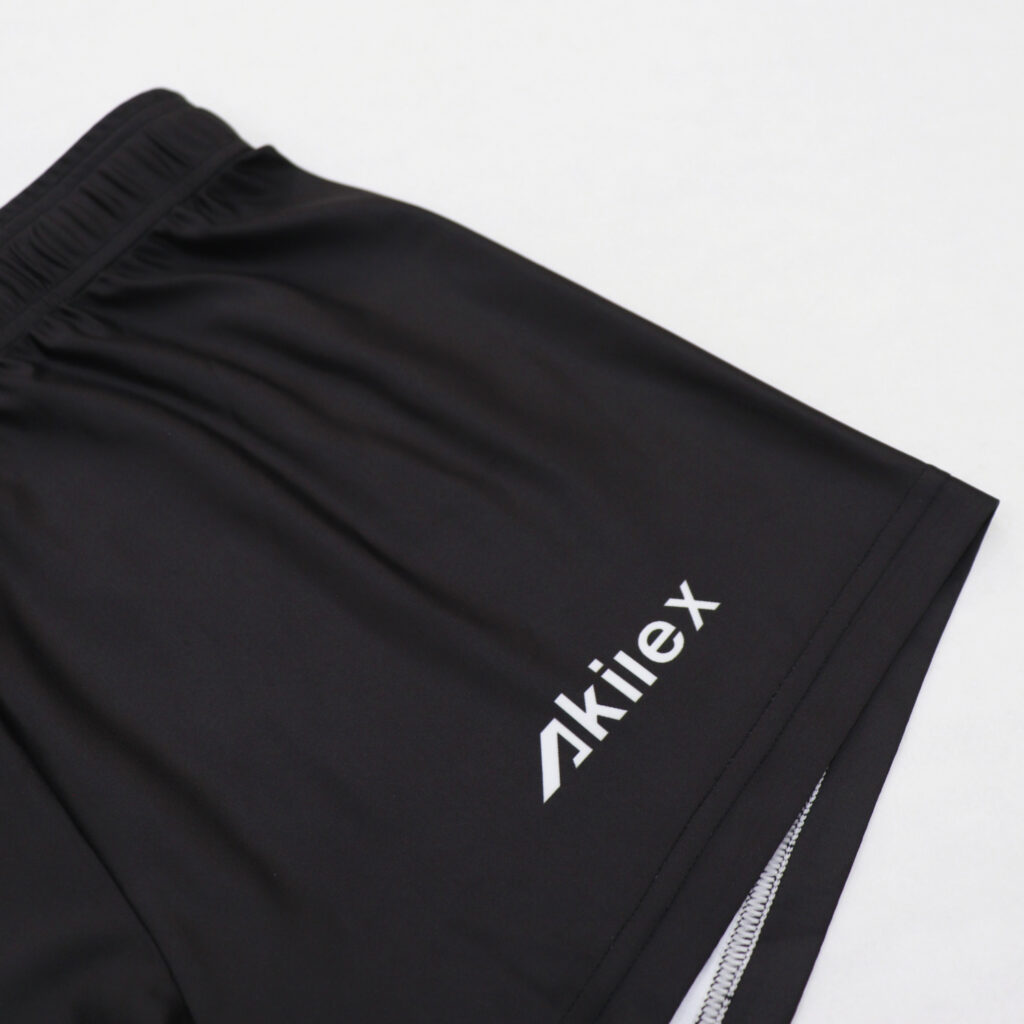 Akilex logo and side panel detail on black volleyball shorts