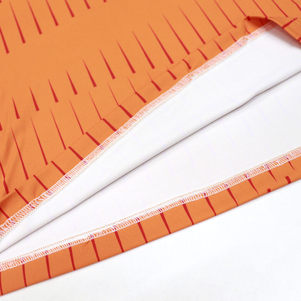 Flatlock hem stitching detail on orange volleyball jersey