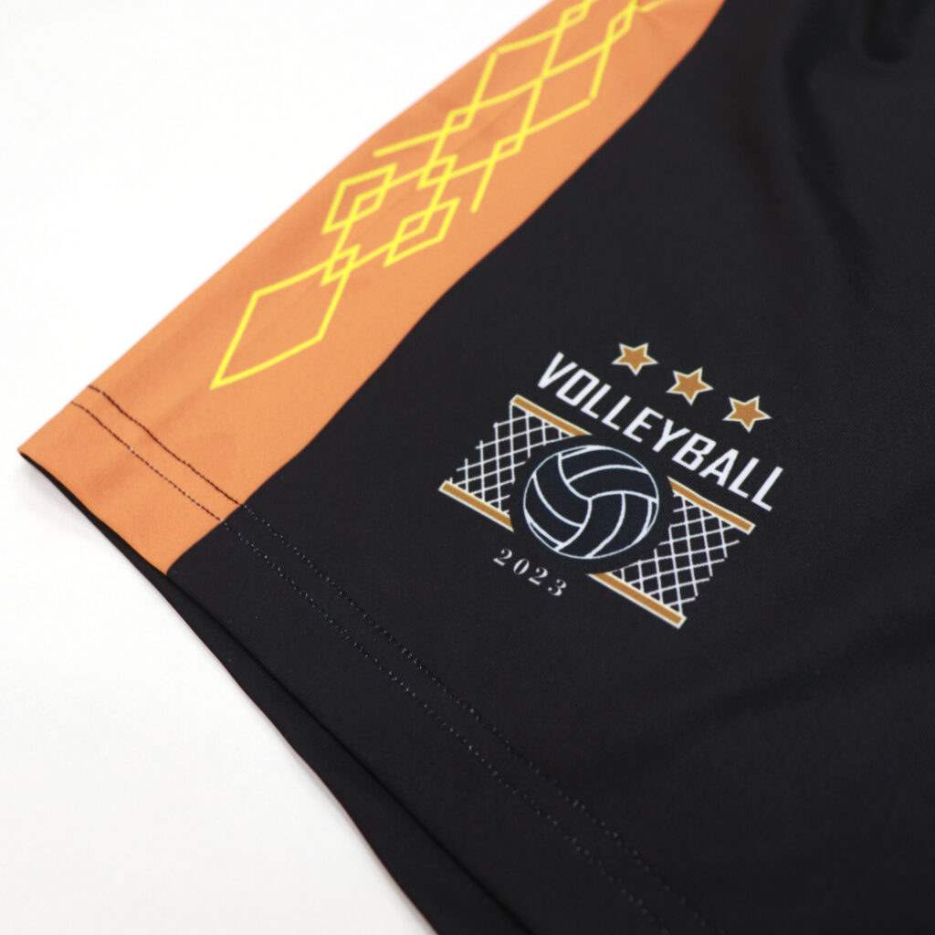 Volleyball logo and side graphic detail on black uniform shorts