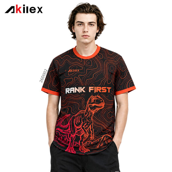 Model facing forward in a black shirt with orange wavy lines, lettering and a red dinosaur graphic.