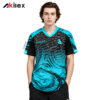 Model facing forward in a black and cyan V-neck shirt with cracked lines, swirling patterns and chest markings.
