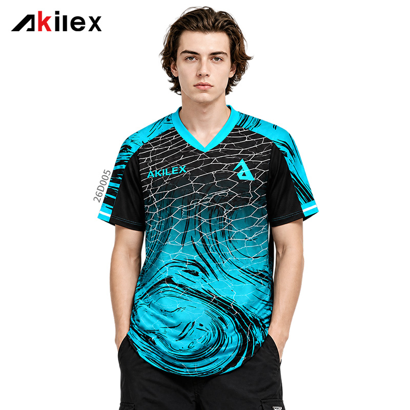 Model facing forward in a black and cyan V-neck shirt with cracked lines, swirling patterns and chest markings.